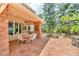 Outdoor patio with a tile surface, lovely outdoor table and chairs, and beautiful landscaping at 28 Indian Paintbrush Dr, Golden, CO 80401