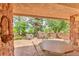 Outdoor patio with stone columns, a tile surface, and beautiful views at 28 Indian Paintbrush Dr, Golden, CO 80401