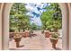 Stunning patio entrance with beautiful planters and stone detail surrounded by lush trees and view at 28 Indian Paintbrush Dr, Golden, CO 80401