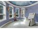 Comfortable sitting area with multiple windows and unique ceiling mural, perfect for relaxation at 28 Indian Paintbrush Dr, Golden, CO 80401