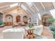 Spacious sunroom with high ceilings, skylights, bar area and elegant decor at 28 Indian Paintbrush Dr, Golden, CO 80401
