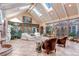 Bright sunroom with skylights, tile floors, and walls of windows overlooking nature at 28 Indian Paintbrush Dr, Golden, CO 80401