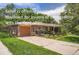 Charming brick home with a front yard and a driveway leading to an attached garage at 4365 Kendall St, Wheat Ridge, CO 80033