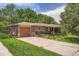 Charming brick home with a well-maintained yard, featuring a single-car garage and mature trees at 4365 Kendall St, Wheat Ridge, CO 80033