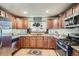 Well-lit kitchen featuring updated appliances, custom cabinetry, and stylish countertops at 4365 Kendall St, Wheat Ridge, CO 80033