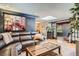 Comfortable living room with stylish decor, a large sofa, and a view into another living space at 4365 Kendall St, Wheat Ridge, CO 80033