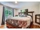 Cozy main bedroom with a large wooden bed frame and access to the outdoor patio at 4365 Kendall St, Wheat Ridge, CO 80033