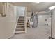 Stairway in basement, features a utility area and carpeted stairs at 1655 Hermosa Dr, Highlands Ranch, CO 80126