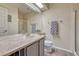 Well-lit bathroom featuring a large mirror, laminate counters, and a glass shower at 1655 Hermosa Dr, Highlands Ranch, CO 80126