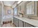 Light-brown bathroom with a shower and bathtub combination, as well as a dual sink vanity at 1655 Hermosa Dr, Highlands Ranch, CO 80126