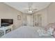 Carpeted bedroom with a large window, closet, ceiling fan, and neutral-colored paint at 1655 Hermosa Dr, Highlands Ranch, CO 80126