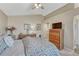 Carpeted bedroom with neutral paint and decor with an adjacent doorway and a ceiling fan at 1655 Hermosa Dr, Highlands Ranch, CO 80126