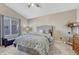 Vaulted bedroom with a window, carpeting, bed, bench, side table, and ceiling fan at 1655 Hermosa Dr, Highlands Ranch, CO 80126