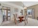 Light-filled dining area with seating for four, neutral carpet, and natural light at 1655 Hermosa Dr, Highlands Ranch, CO 80126