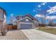 Charming home with a brick-accented facade, a long driveway, and an attached two-car garage at 1655 Hermosa Dr, Highlands Ranch, CO 80126