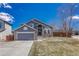 Charming two-story home featuring a gray exterior, brick accents, and a well-manicured front yard at 1655 Hermosa Dr, Highlands Ranch, CO 80126