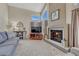 Cozy living room with a fireplace, plush seating, and ample natural light from the large windows at 1655 Hermosa Dr, Highlands Ranch, CO 80126