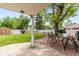 Covered backyard patio with outdoor table and chairs overlooking a well-maintained, spacious lawn and yard at 2112 S Olathe St, Aurora, CO 80013