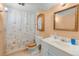 Bathroom featuring a tiled floor, a sink with a mirror, and a bathtub with a shower at 2112 S Olathe St, Aurora, CO 80013