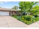 Attractive home featuring a well-kept lawn and vibrant flowerbeds at 2112 S Olathe St, Aurora, CO 80013