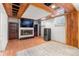 Cozy living room with a fireplace, a large screen TV, wood floors, and a mini refrigerator at 2112 S Olathe St, Aurora, CO 80013