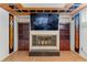 Living room featuring a fireplace, built-in shelves, and a large screen TV at 2112 S Olathe St, Aurora, CO 80013