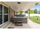 Covered patio featuring a hot tub and a peaceful backyard at 2112 S Olathe St, Aurora, CO 80013