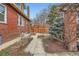 A walkway and landscaping define the side yard, with a fence and pergola defining the exterior of the property at 579 S Sherman St, Denver, CO 80209