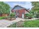Brick home with a spacious backyard, garden beds, and patio area at 579 S Sherman St, Denver, CO 80209