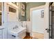 Bathroom featuring green walls, pedestal sink, and a separate shower at 579 S Sherman St, Denver, CO 80209