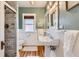Well-maintained bathroom boasts a tiled shower, pedestal sink, and wainscoting at 579 S Sherman St, Denver, CO 80209