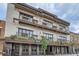 A three story brick building with dark metal awnings and balcony seating areas at 579 S Sherman St, Denver, CO 80209