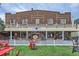 A three-story brick building with a decorative metal gate and a white picket fence at 579 S Sherman St, Denver, CO 80209