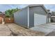 A detached two car garage with gray siding and a white garage door, complemented by a concrete driveway at 579 S Sherman St, Denver, CO 80209