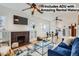 Bright living room boasts a decorative fireplace, hardwood floors, and ceiling fan at 579 S Sherman St, Denver, CO 80209