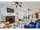 Bright living room featuring hardwood floors, fireplace, and a ceiling fan at 579 S Sherman St, Denver, CO 80209