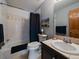 Bathroom featuring neutral colored tiling, bath tub, and sink at 31518 Niakwa Rd, Evergreen, CO 80439