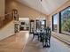 Bright dining area with a vaulted ceiling, large windows, and an elegant chandelier at 31518 Niakwa Rd, Evergreen, CO 80439