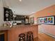 Kitchen bar featuring wooden stools, granite countertops, dark cabinets, and stainless appliances at 31518 Niakwa Rd, Evergreen, CO 80439