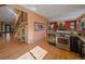 Open layout showcasing the kitchen with gas range and stainless steel appliances at 31518 Niakwa Rd, Evergreen, CO 80439