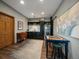 Kitchenette featuring tile backsplash, stainless steel refrigerator, and checker board table at 31518 Niakwa Rd, Evergreen, CO 80439