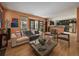 Living room with hardwood floors open to kitchen with doors leading to sunroom at 31518 Niakwa Rd, Evergreen, CO 80439