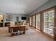 Open living room with large windows and balcony access at 31518 Niakwa Rd, Evergreen, CO 80439