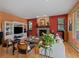 Cozy living room featuring a stone fireplace, hardwood floors, and natural light at 31518 Niakwa Rd, Evergreen, CO 80439