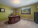 Inviting home office space with a large wooden desk, natural light, and scenic views at 31518 Niakwa Rd, Evergreen, CO 80439
