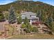 Aerial view of home's backyard and lush greenery at 31518 Niakwa Rd, Evergreen, CO 80439