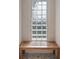 Modern shower with a wooden bench seat and glass block window at 31518 Niakwa Rd, Evergreen, CO 80439