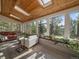 Sunroom with many windows, skylights, hardwood floors and access to nature at 31518 Niakwa Rd, Evergreen, CO 80439