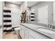 Bright bathroom with dual sinks, granite countertops, and a shower with black/white curtains at 10397 Helsinki St, Parker, CO 80134