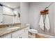 Bathroom featuring granite countertop, white cabinets, and decorative wooden towel rack at 10397 Helsinki St, Parker, CO 80134